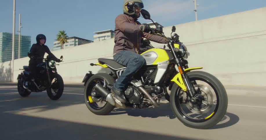 Three men on motorcycles travel through the city and the underpass