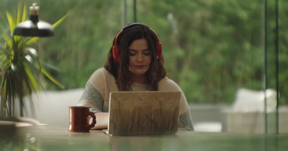 A woman is typing on her laptop
