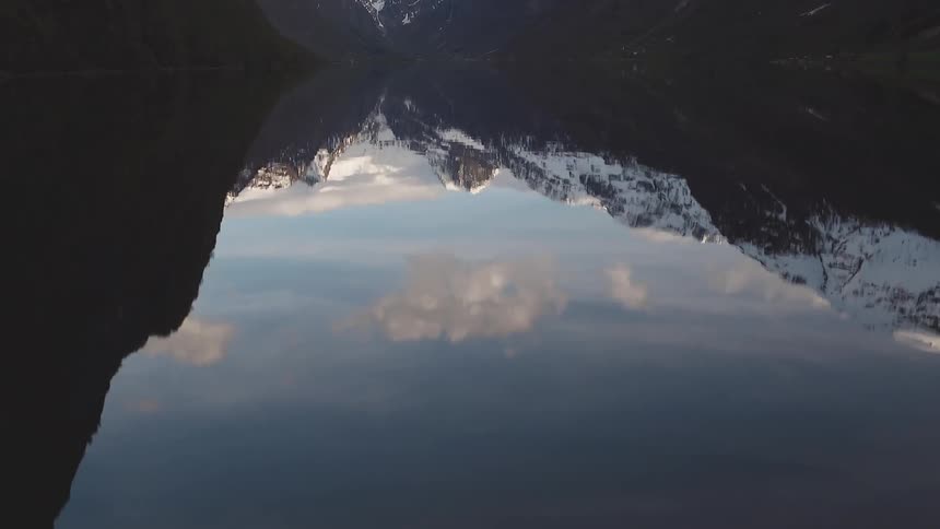 Time-lapse of wilderness reflecting in some water