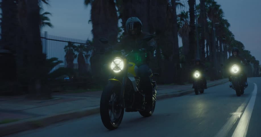 A clip of bikers riding on a freeway in the night