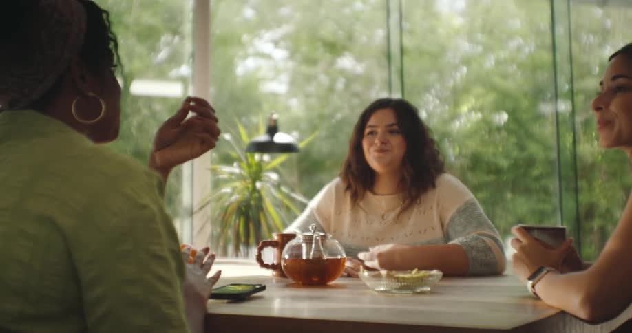 A clip of women having a discussion on a table