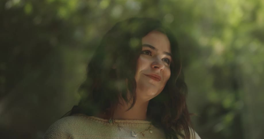 Close up of a womans face as she looks sad then smiles