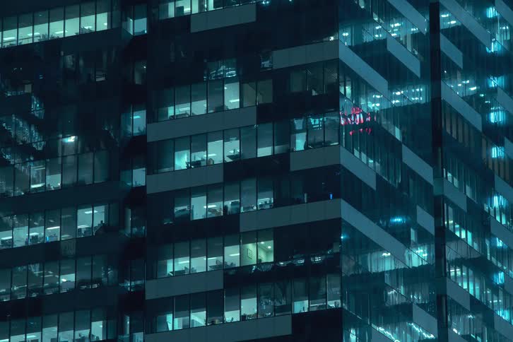 A time lapse of buildings lights turning on at night