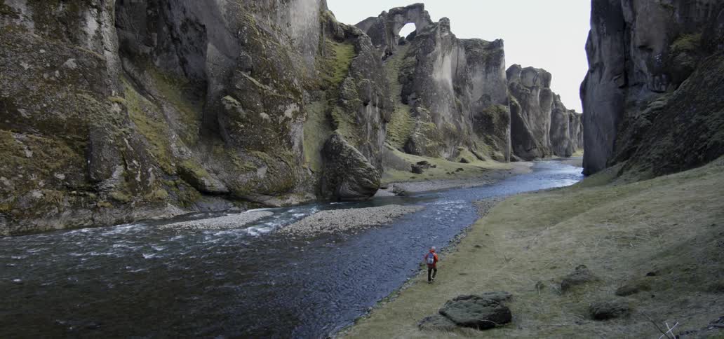 A man walks near a river