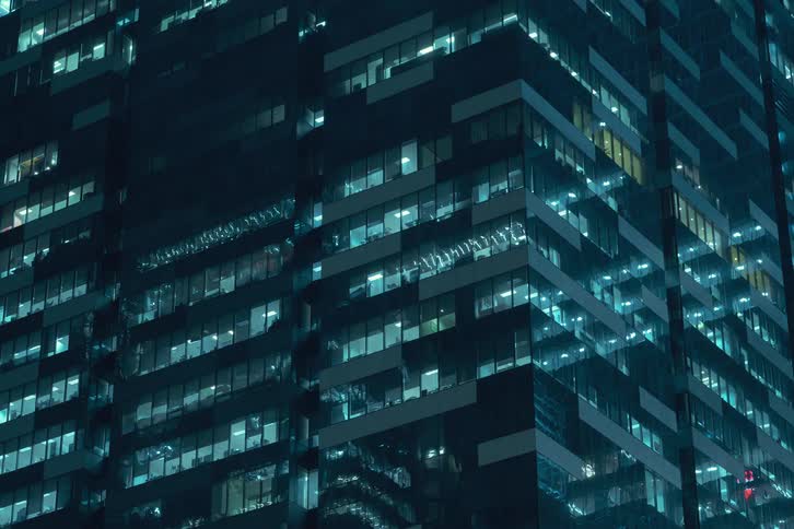 Pattern formed by bright skyscraper windows changes as the interior lights turn on and off during the night