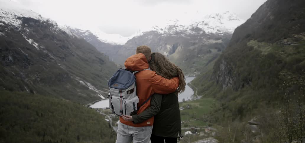 A man and woman embracing in a scenic nature setting