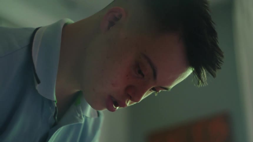 Close up of a boys face as he looks down contemplatively