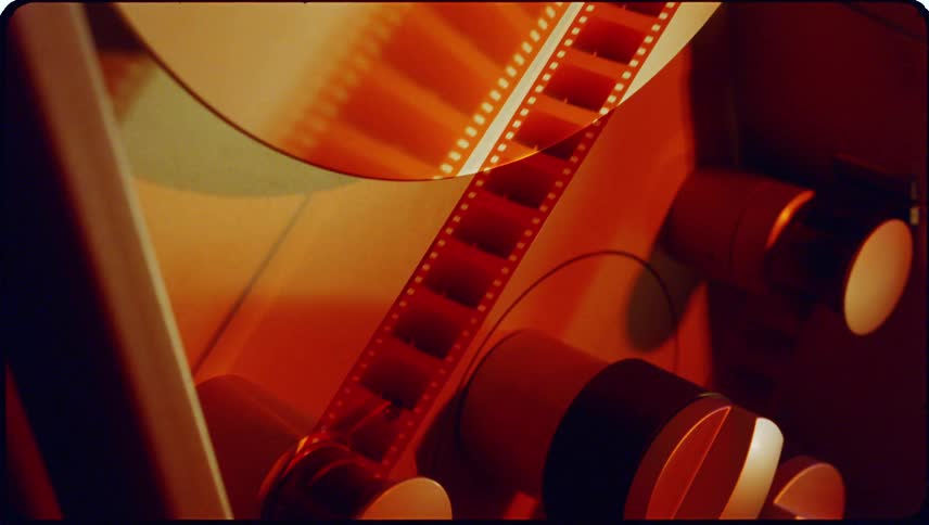 A long film reel moving through a machine slowly