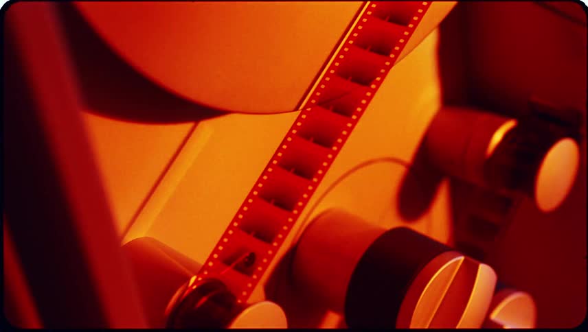 Closeup view of film threading equipment with cylindrical reels and components