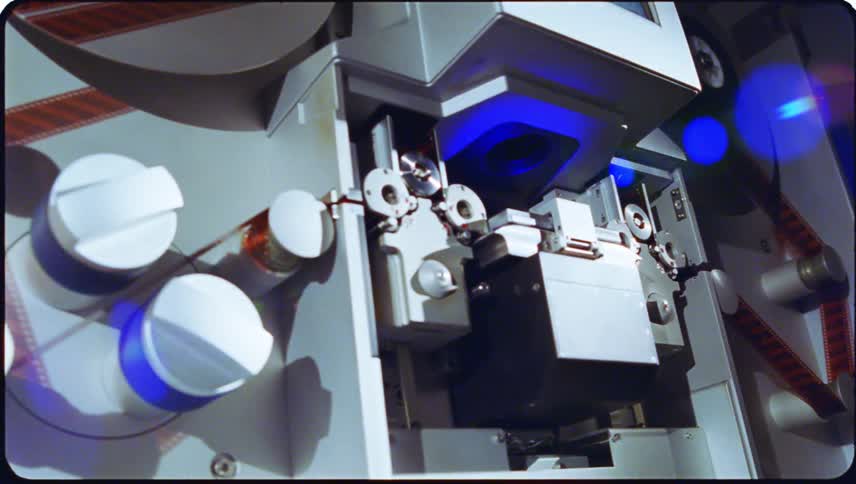 Closeup view of film threading equipment with cylindrical reels and components