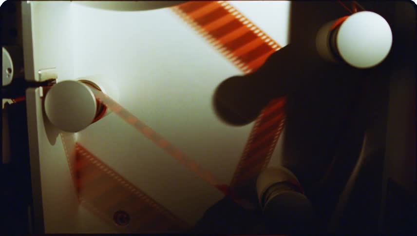 Closeup view of film threading equipment with cylindrical reels and components