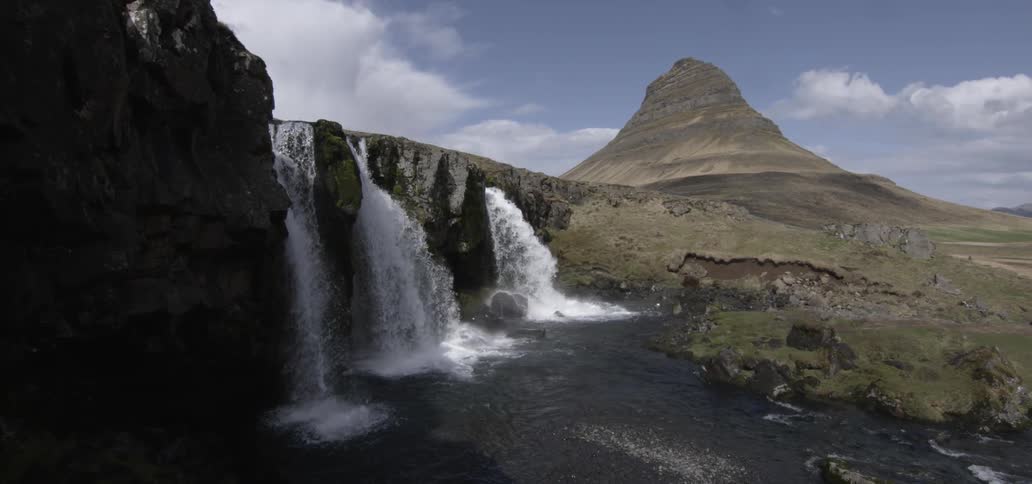 View of three waterfalls splashing into a river