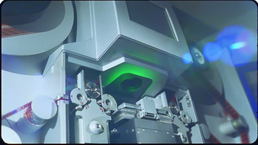 Closeup view of film threading equipment with cylindrical reels and components