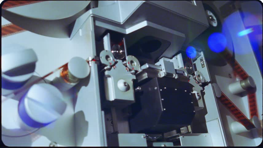 Closeup view of film threading equipment with cylindrical reels and components