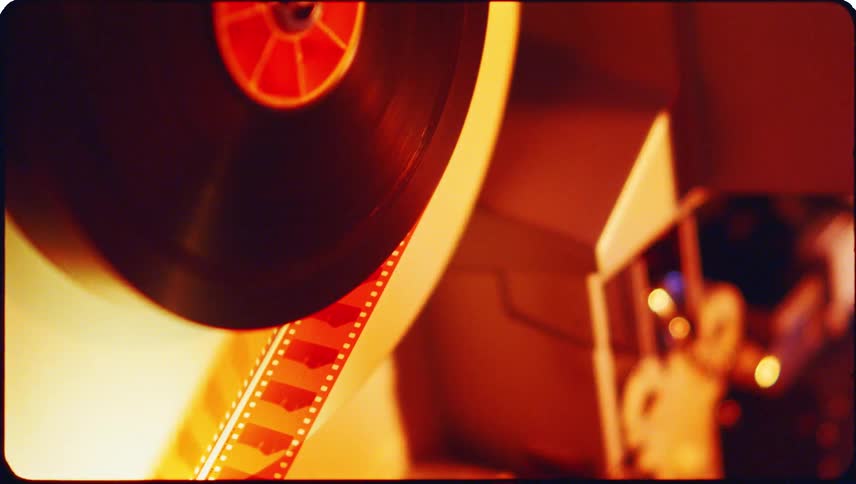 Closeup view of film threading equipment with cylindrical reels and components