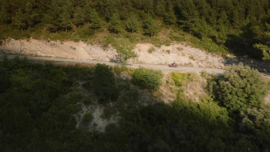 An aerial clip of a biker traveling the hill