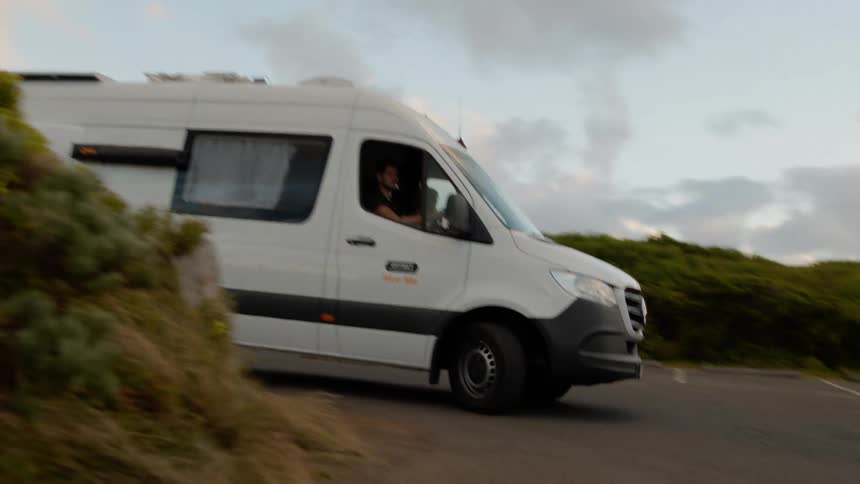 Van travels past forested countryside during a road trip