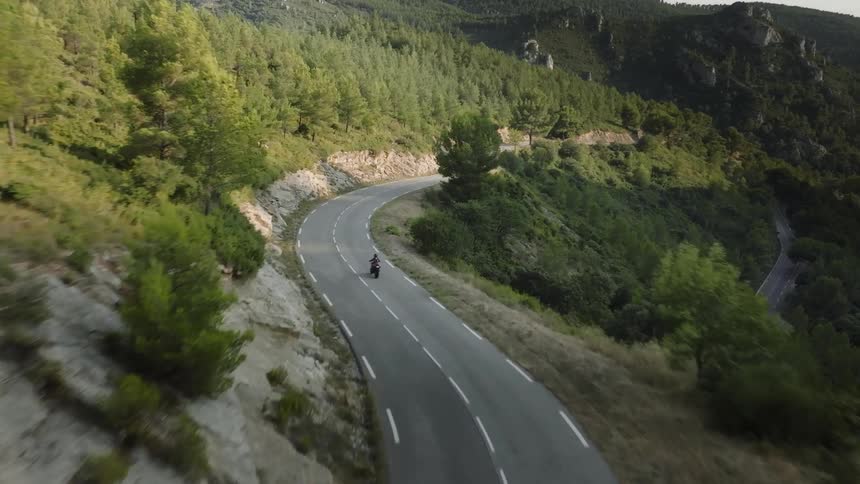 An aerial clip of a bike traveling through the mountain
