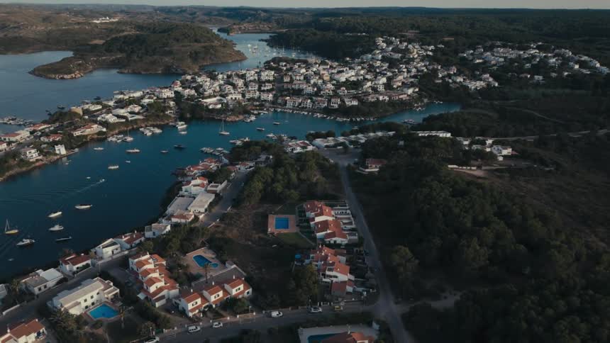 An aerial clip of a city closer to the forest and shore