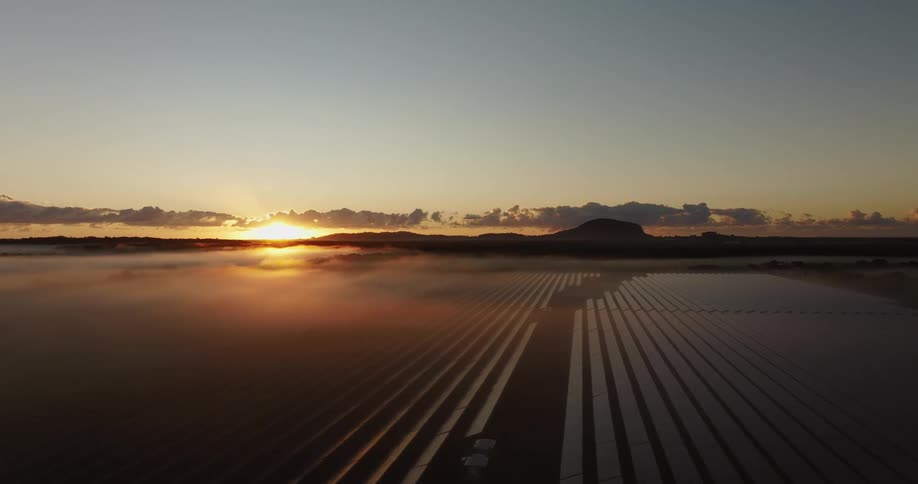 The landscape is full of solar panels at sunrise