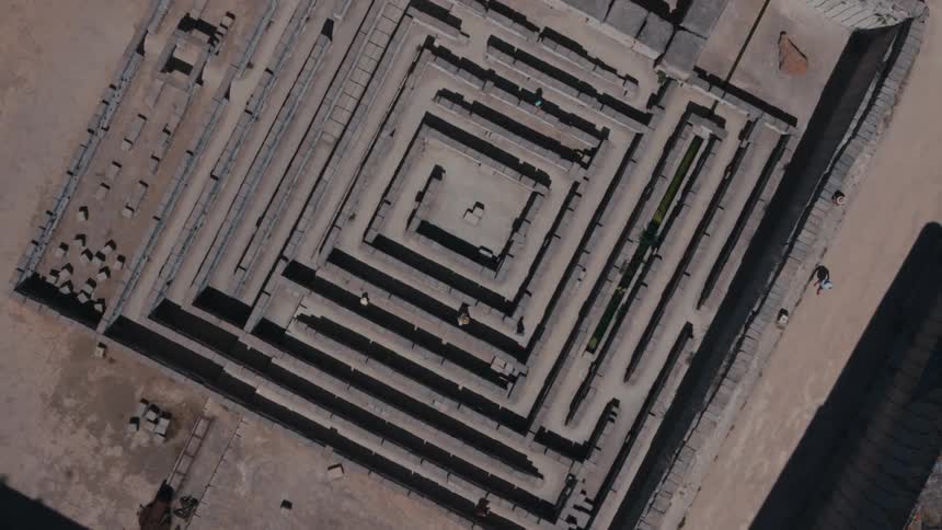 Several people walk and run through a maze