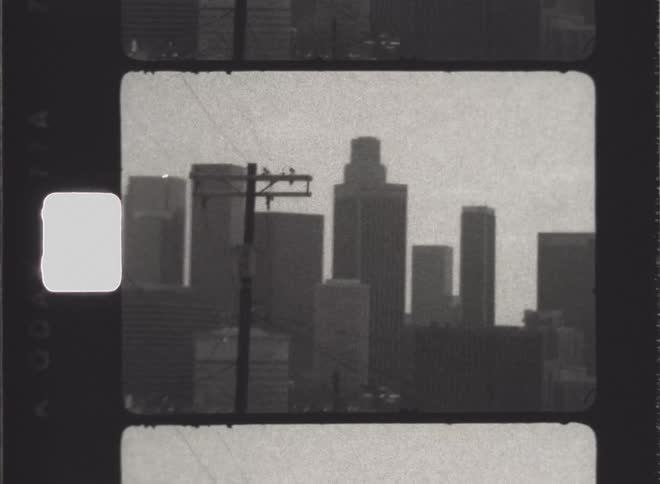Vehicle driving along highway passes city skyline