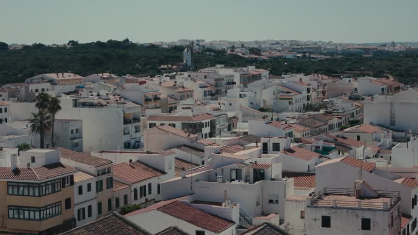 Aerial of condensed housing rooftops on a bright sunny day