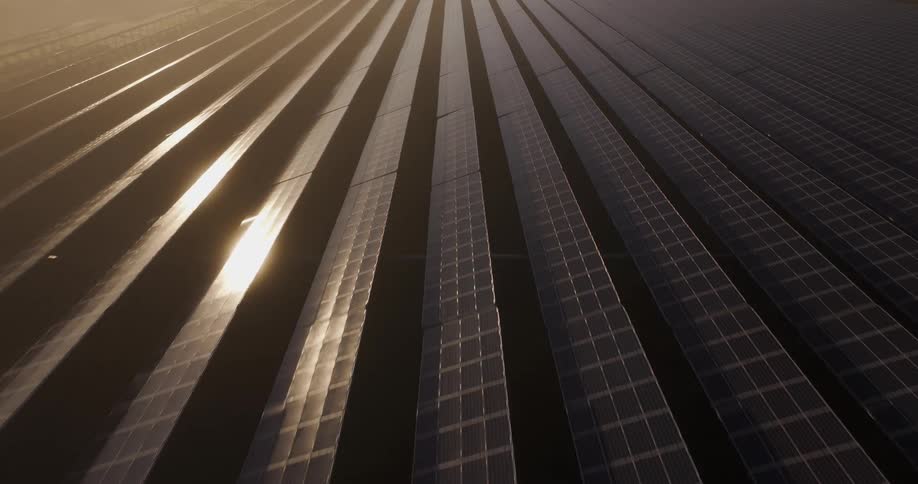 Rows of solar panels are being shown moving backwards