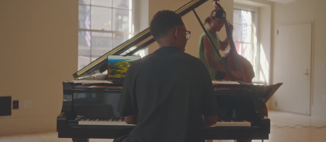 A clip of two black male playing musical instruments