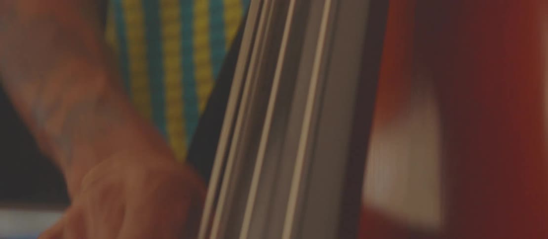 A young man in a cap plays a double bass