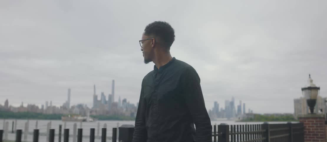 A clip of a man walking by the road side