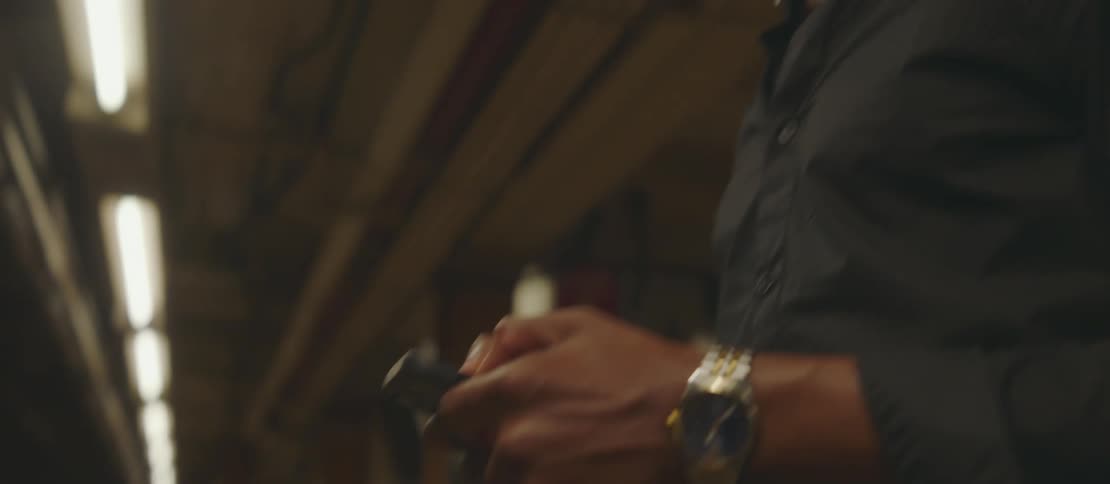 A clip of a male operating a smart phone while standing