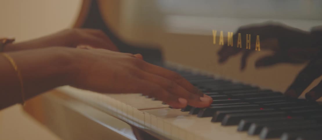 A young man nodding his hand as he plays piano very fast