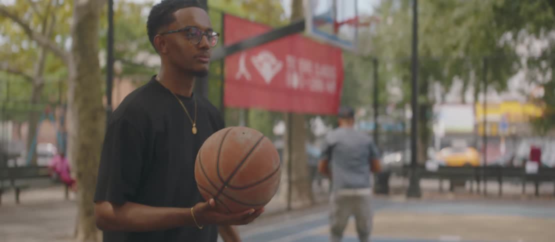 Man on a court holding a basketball