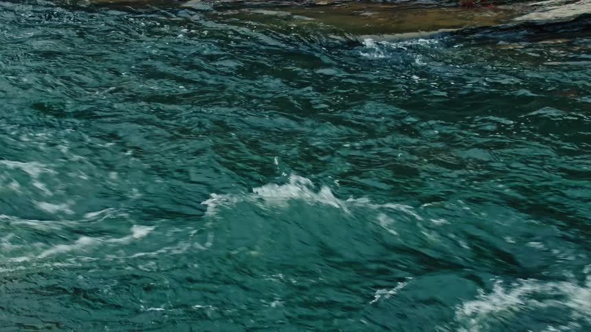 Waters of a stream flowing from a river
