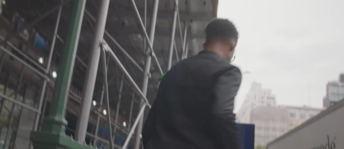 Person walking down the entrance of a subway station in the city