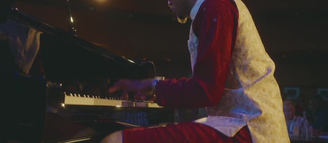 A musician performing piano on stage