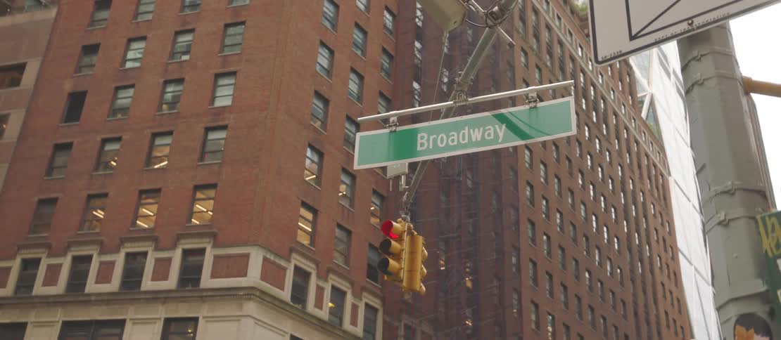 The city street has a green sign