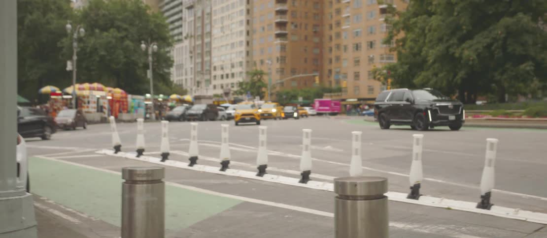Taxis and private cars passing through an avenue in a metropolis