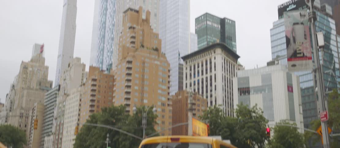 Taxi vans lined up on a street in a metropolis