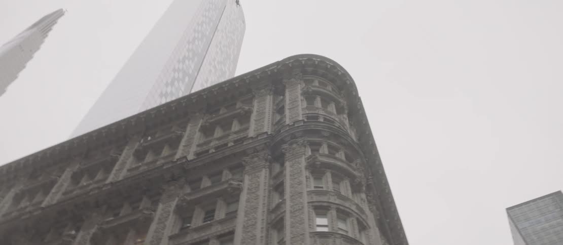 An old classical building at the corner of a modern tower block
