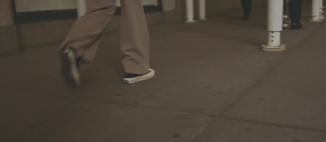 Legs of people walking through a city