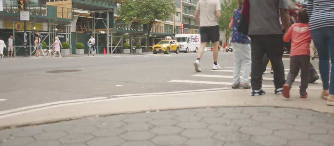 Pedestrians cross the street in the city