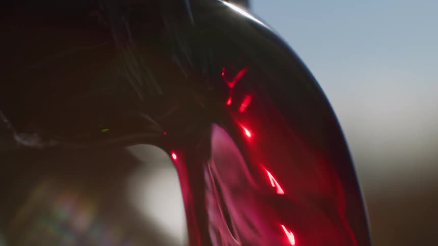 Extreme close up on a glass bottle pouring liquid