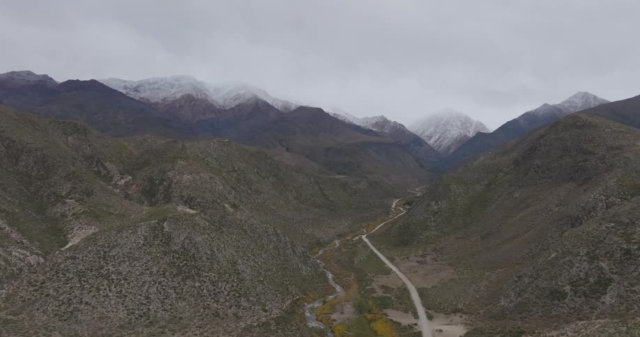 A dirt path runs through the mountain range