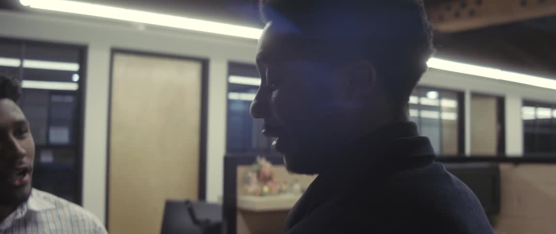 A close up of a couple of coworkers talking in the office