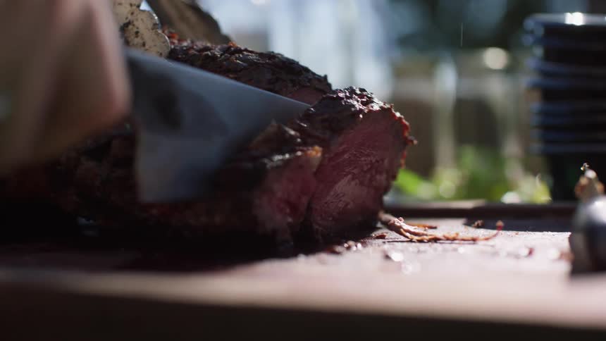 A person is slicing a steak