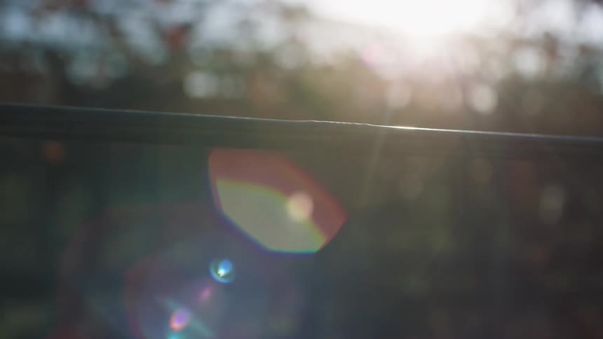 Sunlight bouncing off a wet dripping handrail