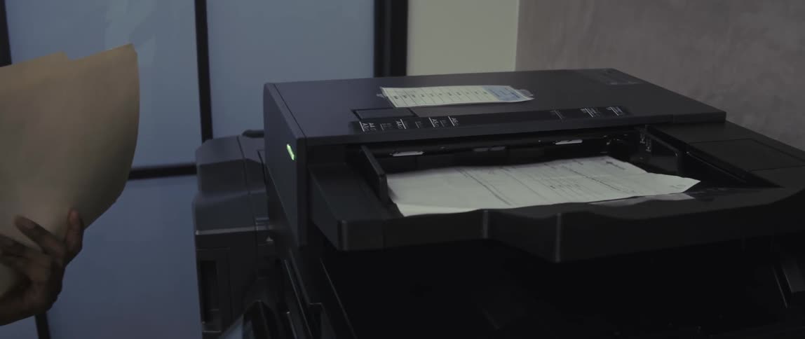 Man in an office using a photocopier