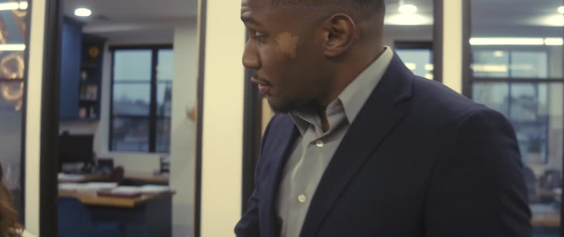 Arriving boss talks to his employees before entering his private office